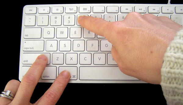 Two hands using keyboard to create a screenshot