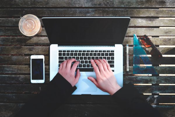 Person typing on a computer keyboard to illustrate the blog article "“How Do People with Disabilities Use the Web?”