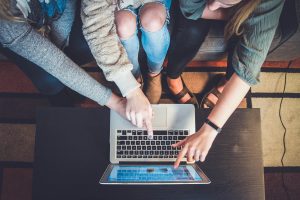 Three people sitting on a couch commenting on a blog