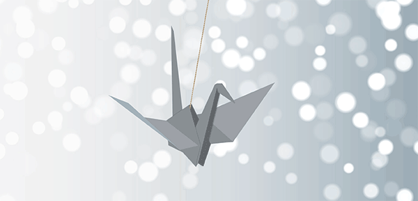 animated gif of a gray paper crane swinging in front of twinkling lights